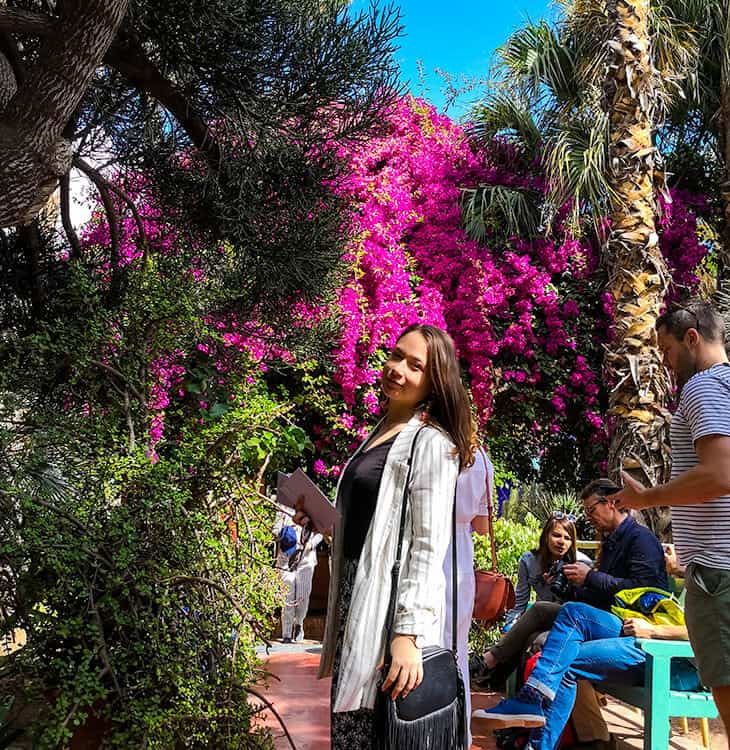 Girl posing in front of flowers at Jardin Majorelle in Marrakech