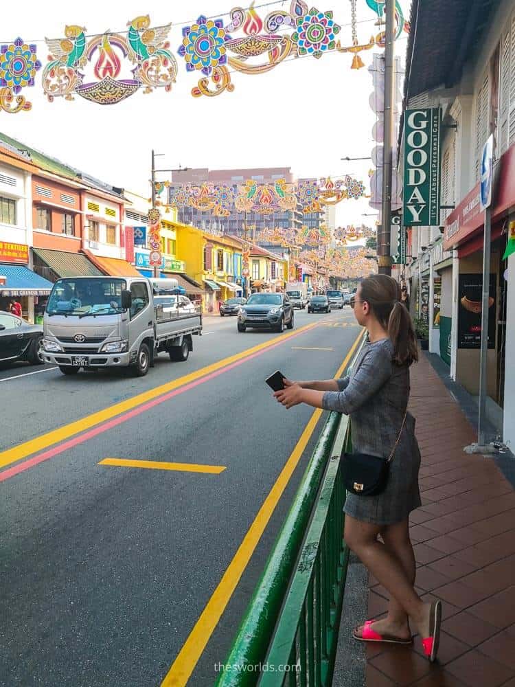 Girl standing next to street in India neighborhood in Singapore