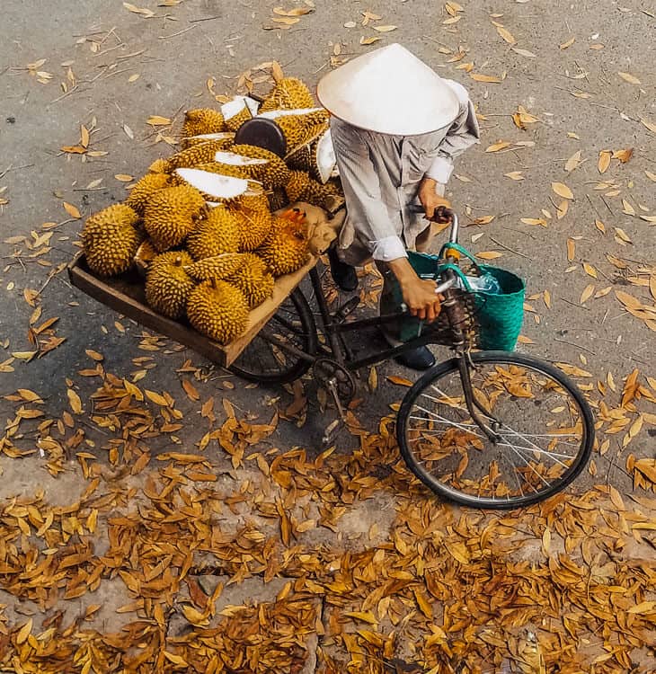 Person with bicycle selling durian in Singapore