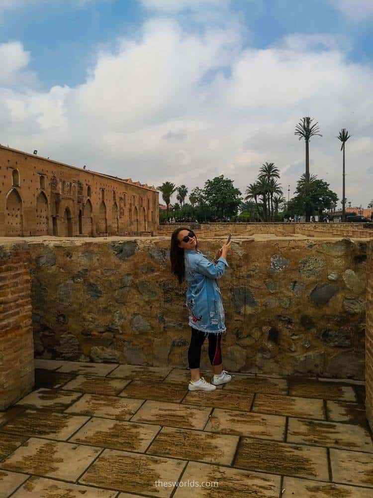 Girl taking a picture of ruins of Koutoubia in Marrakech
