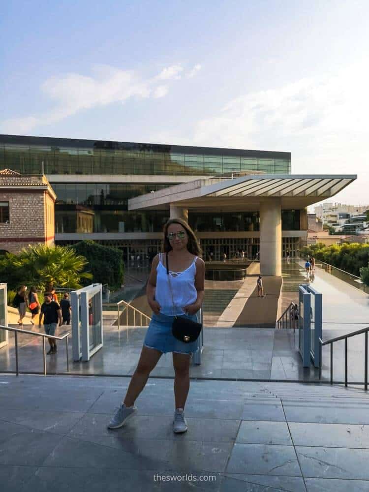 Girl standing in front of entrance to acropolis museum in Athens