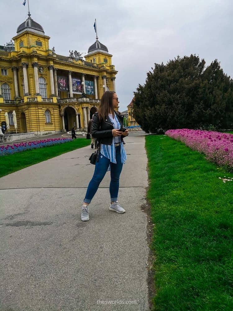 Girl posing in front of Croatian national theater in Zagreb