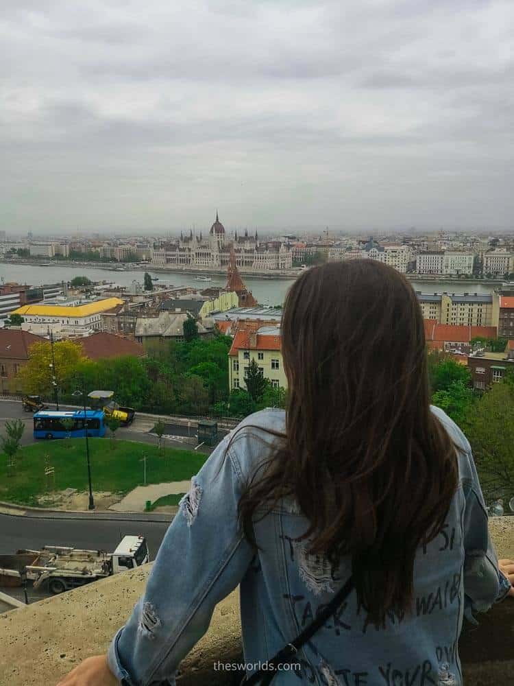 Girl looking at Hungarian parliament in Budapest