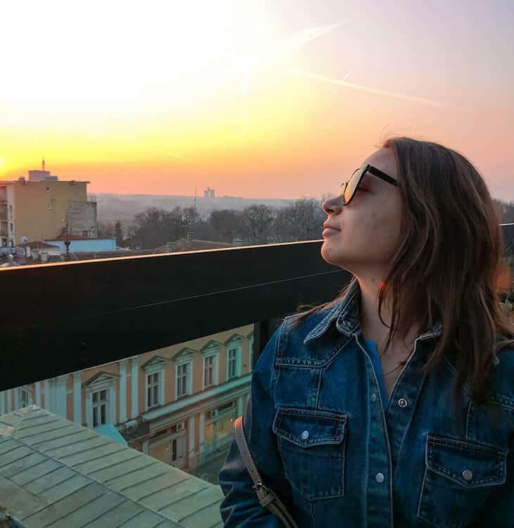 Girl looking at sunset at hotel rooftop in Belgrade