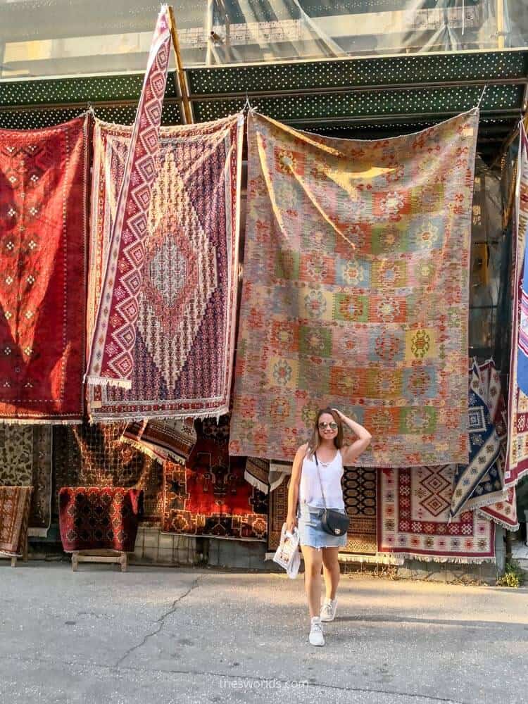 Girl posing in front of carpets in Athens
