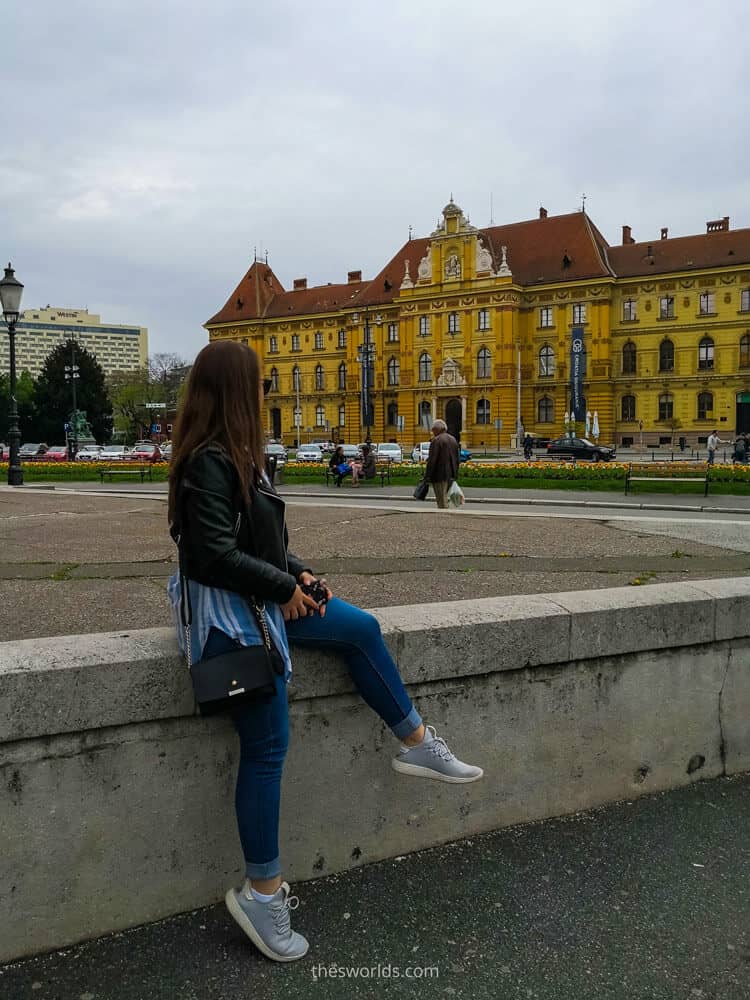 Girl posing in front of museum of Arts and Crafts in Zagreb
