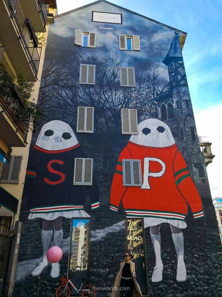 Two ghost graffiti on building in Milan with girl at the bottom of the building