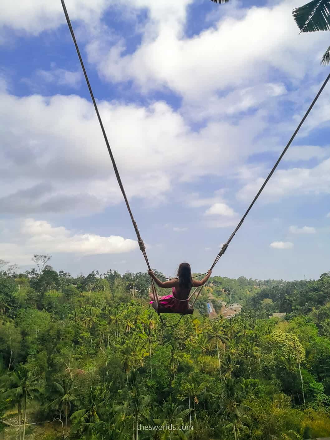 Girl swinging with forest in the background