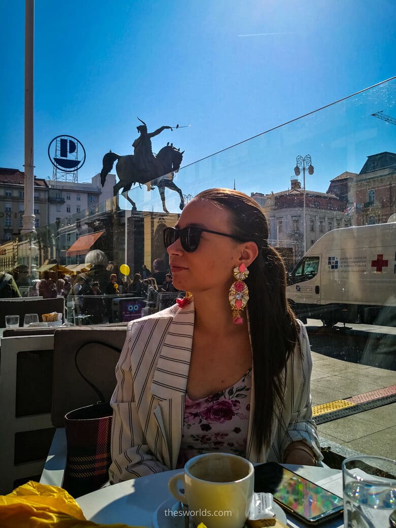 Girl drinking coffee at Ban Josip Jelacic square in Zagreb