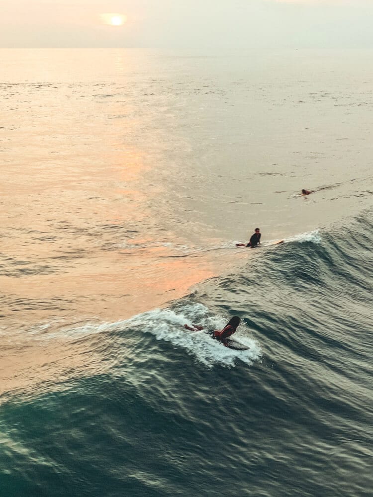 People surfing on waves at Canggu beach