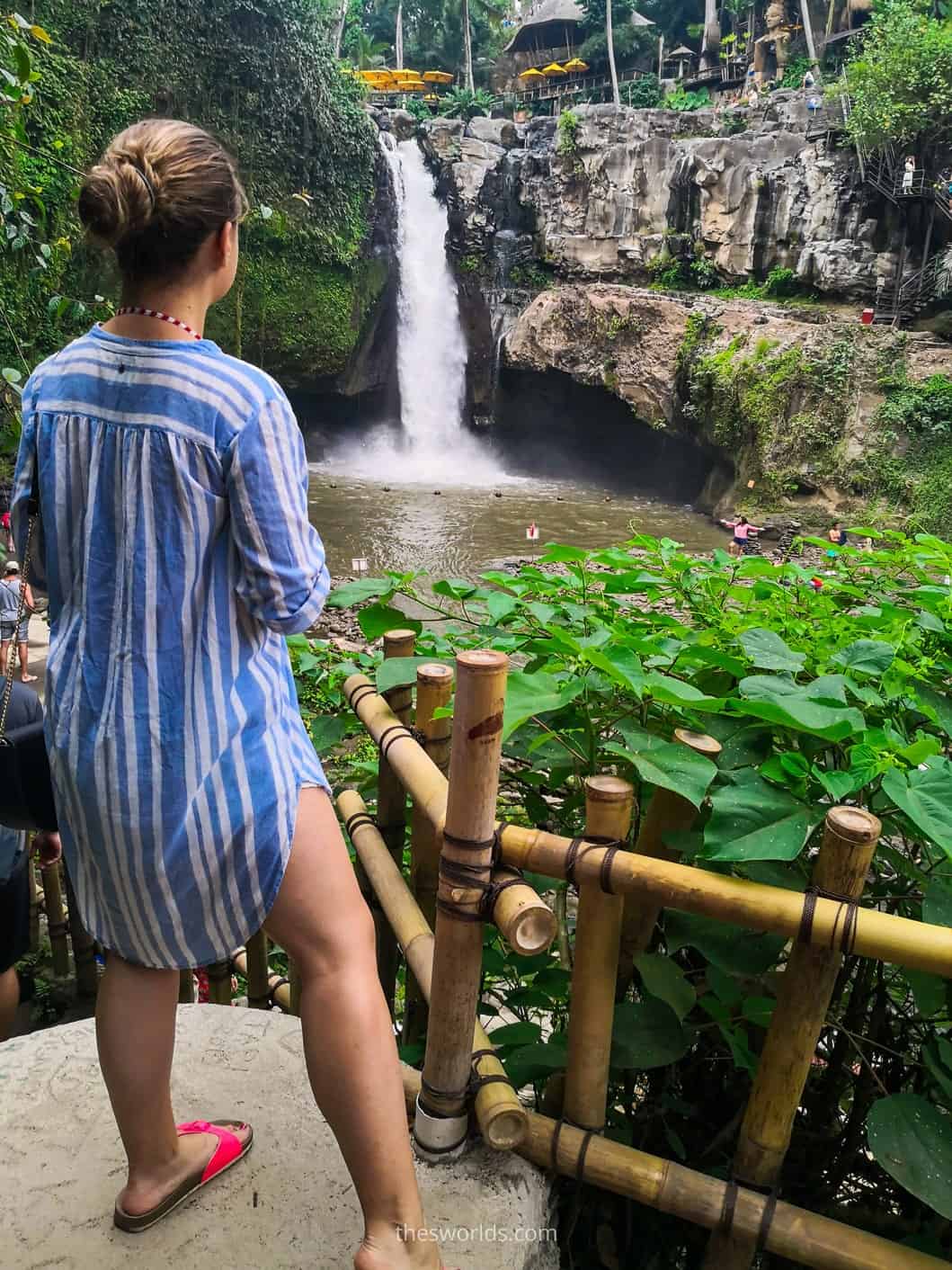 Girl looking at Tegenungan waterfall Bali