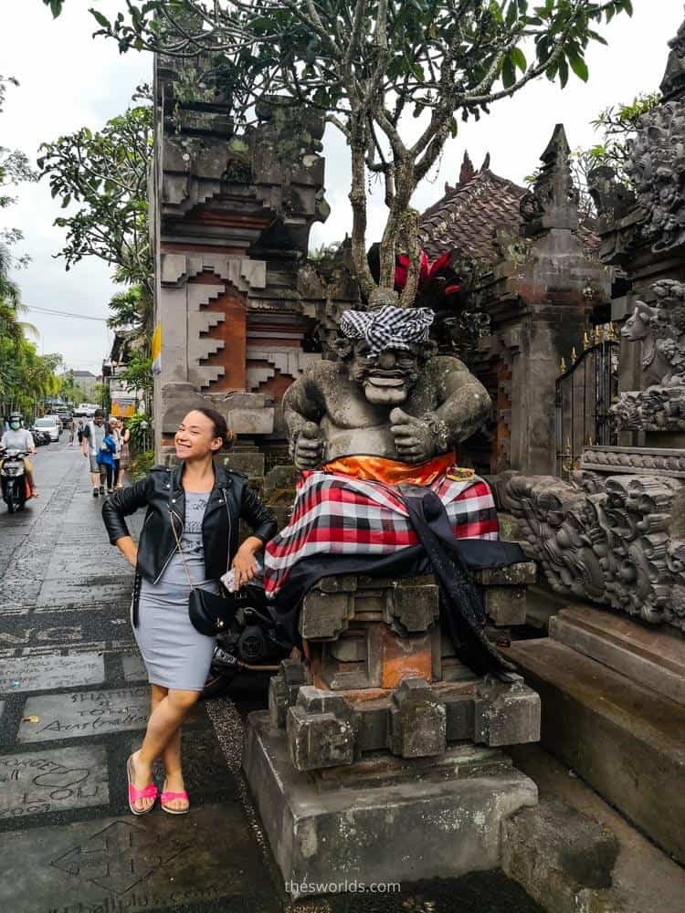 Girl posing next to statue at Ubud