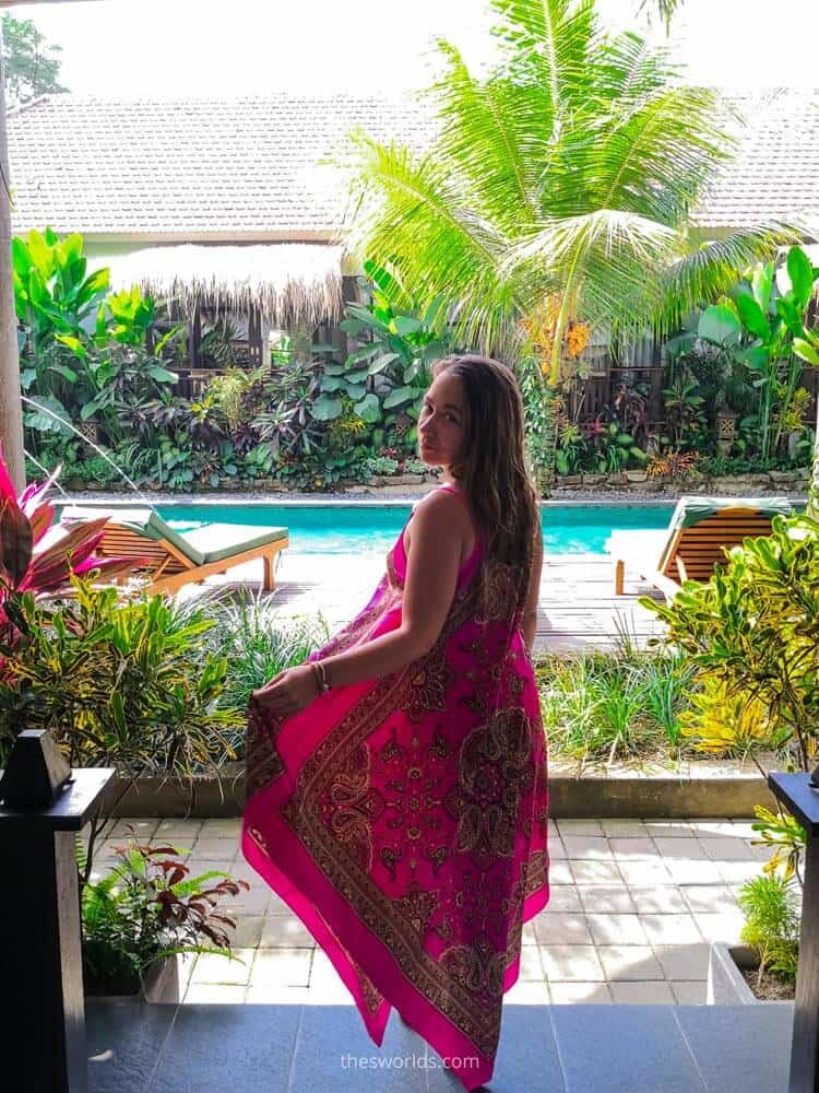 Girl standing at entrance to villa in Ubud with pool in the background