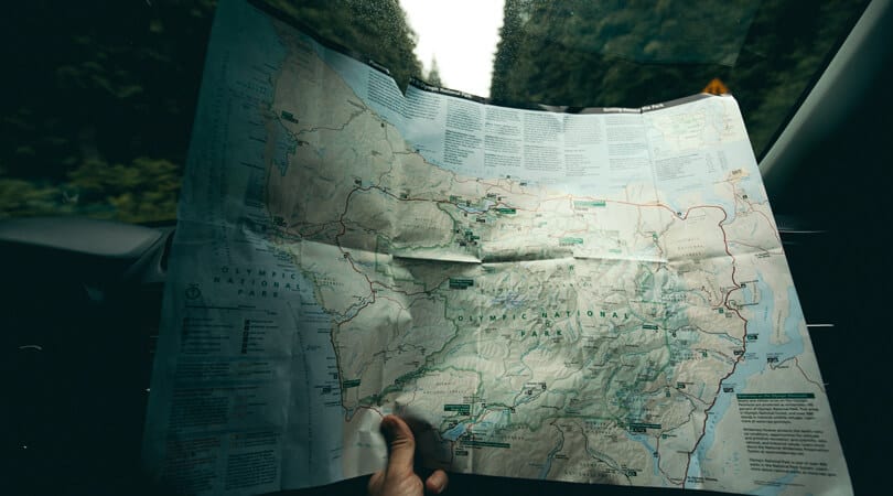 Person looking at a map in car of Olympic national park Washington