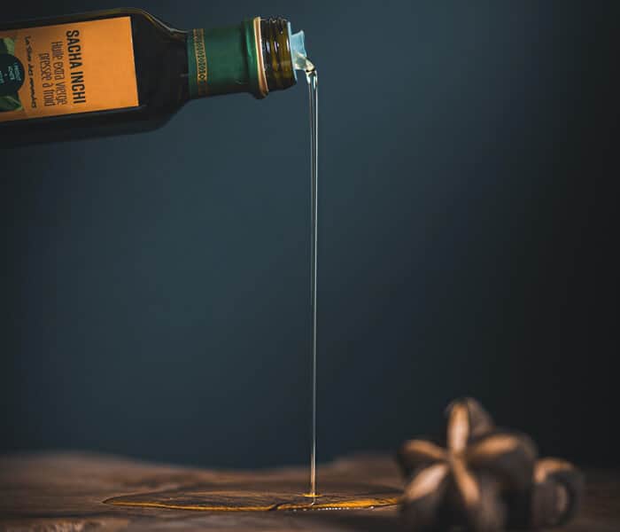 Pouring olive oil on Table