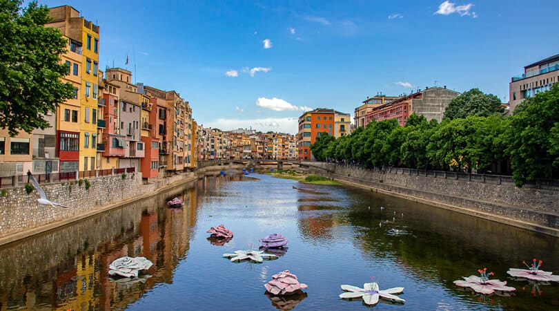 River surrounded by houses and trees in Girona